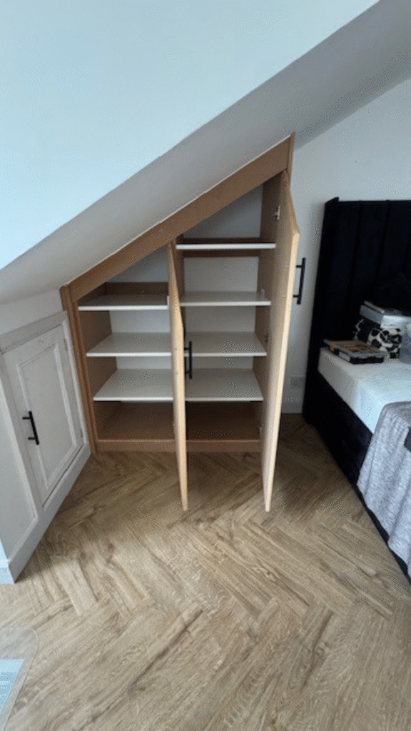 Bespoke fitted wardrobes built into a slanted bedroom roof